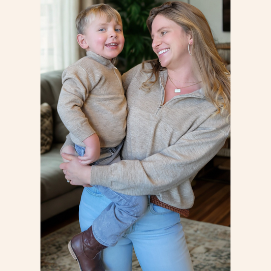 Woman holding a child in a cozy living room setting