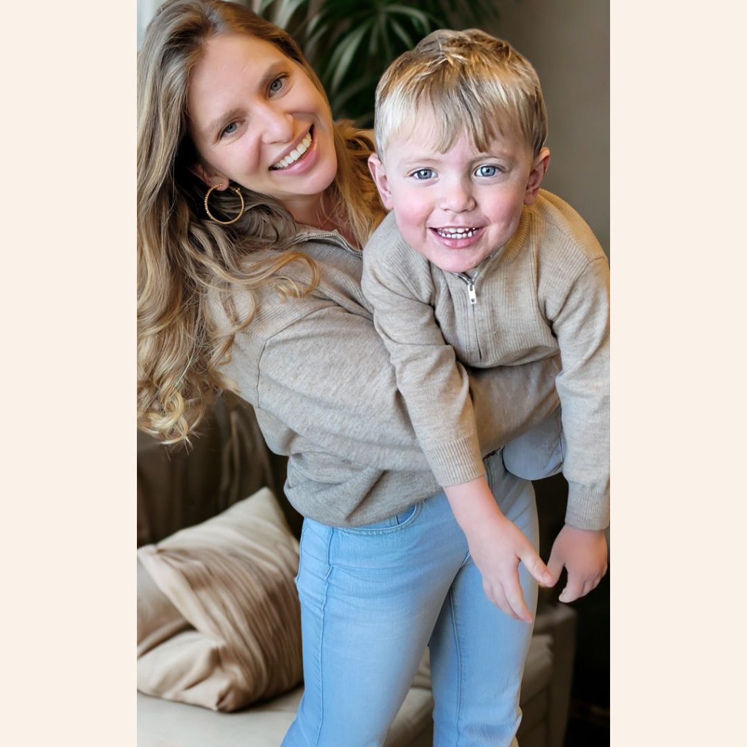 Woman and child smiling together in a cozy indoor setting