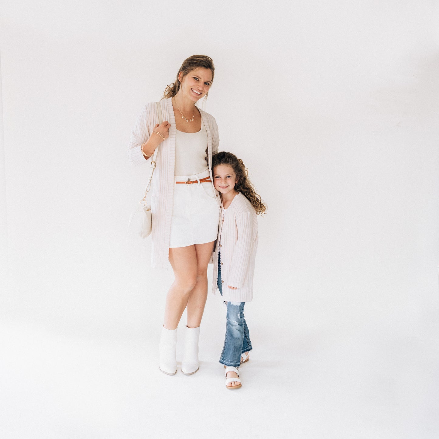 Woman and child standing together on a white background